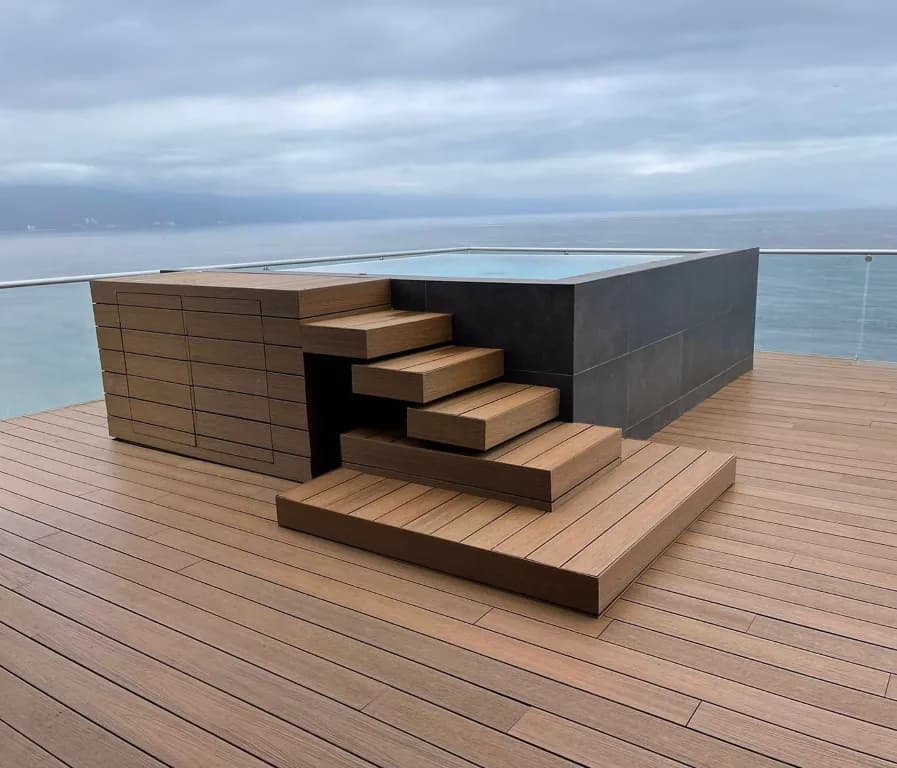 Terrace with a raised hot tub and WPC deck steps overlooking the ocean