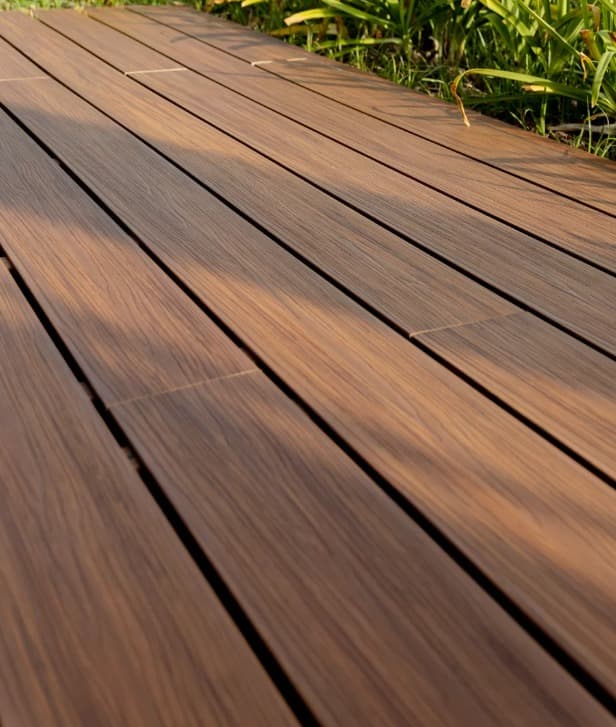 Close-up of dark brown WPC decking in afternoon light