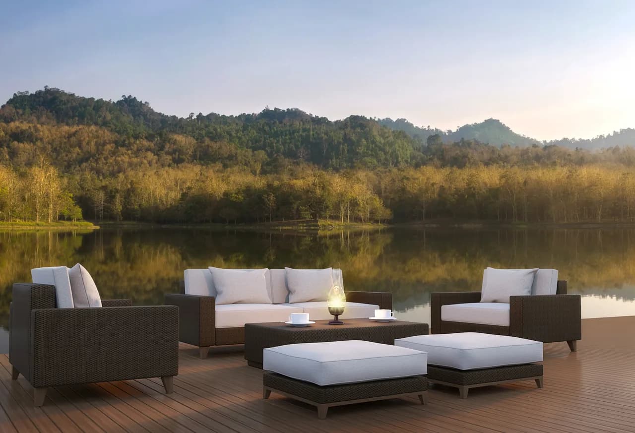Outdoor seating area on WPC decking overlooking a lake and a wooded hill