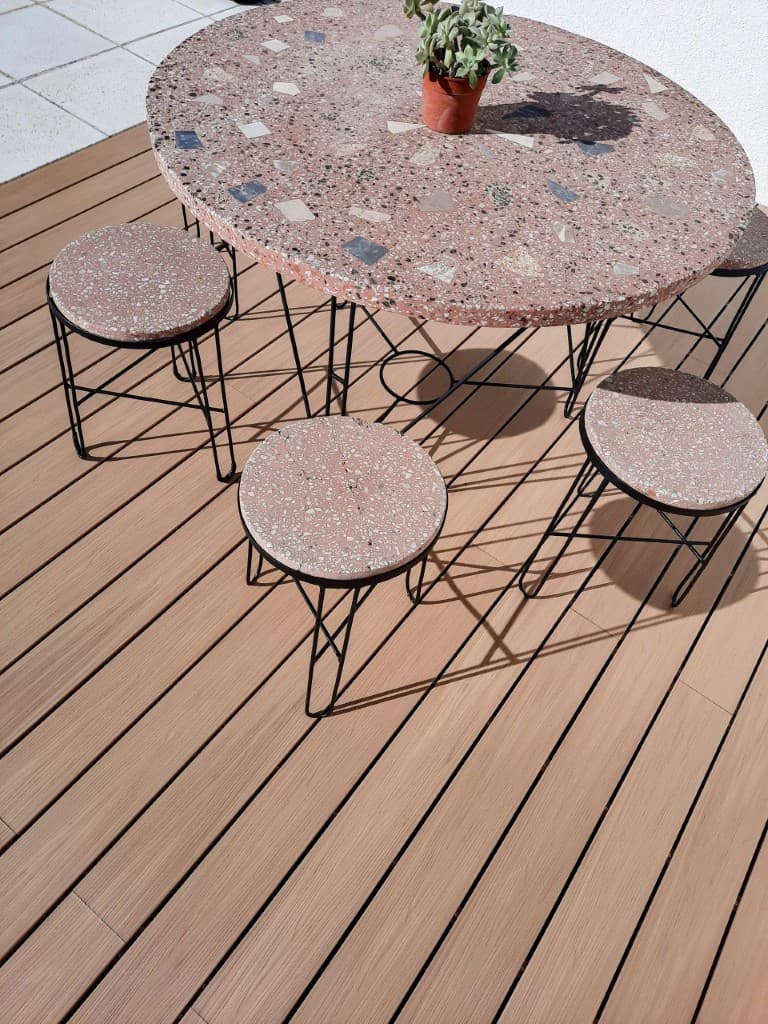 Terrazzo table and benches on wood-tone WPC decking