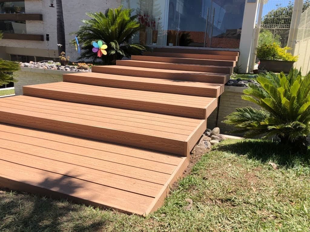 Copper-tone WPC deck stairs in a garden