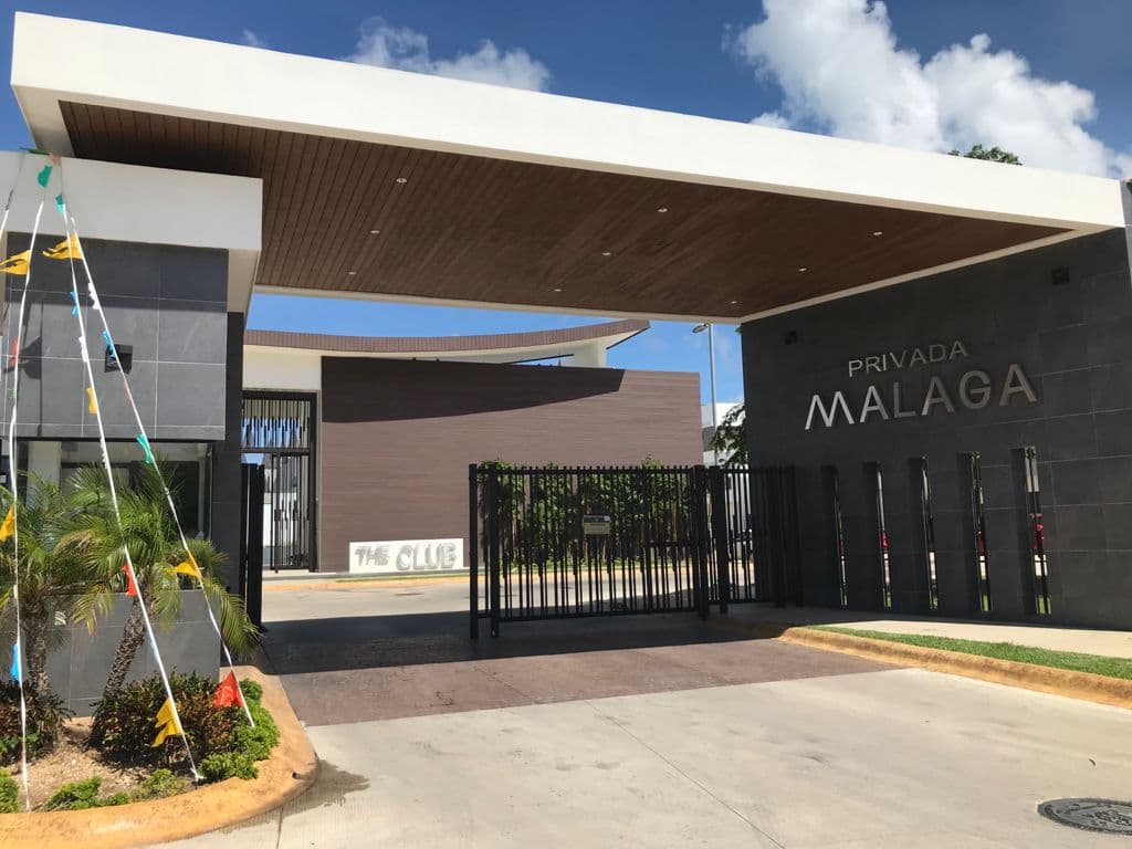 Residential community entrance with a wood-tone WPC cladding ceiling