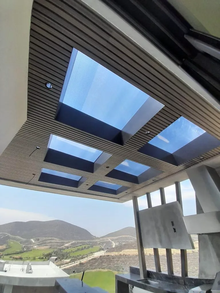 WPC cladding ceiling with skylights and hills in the background