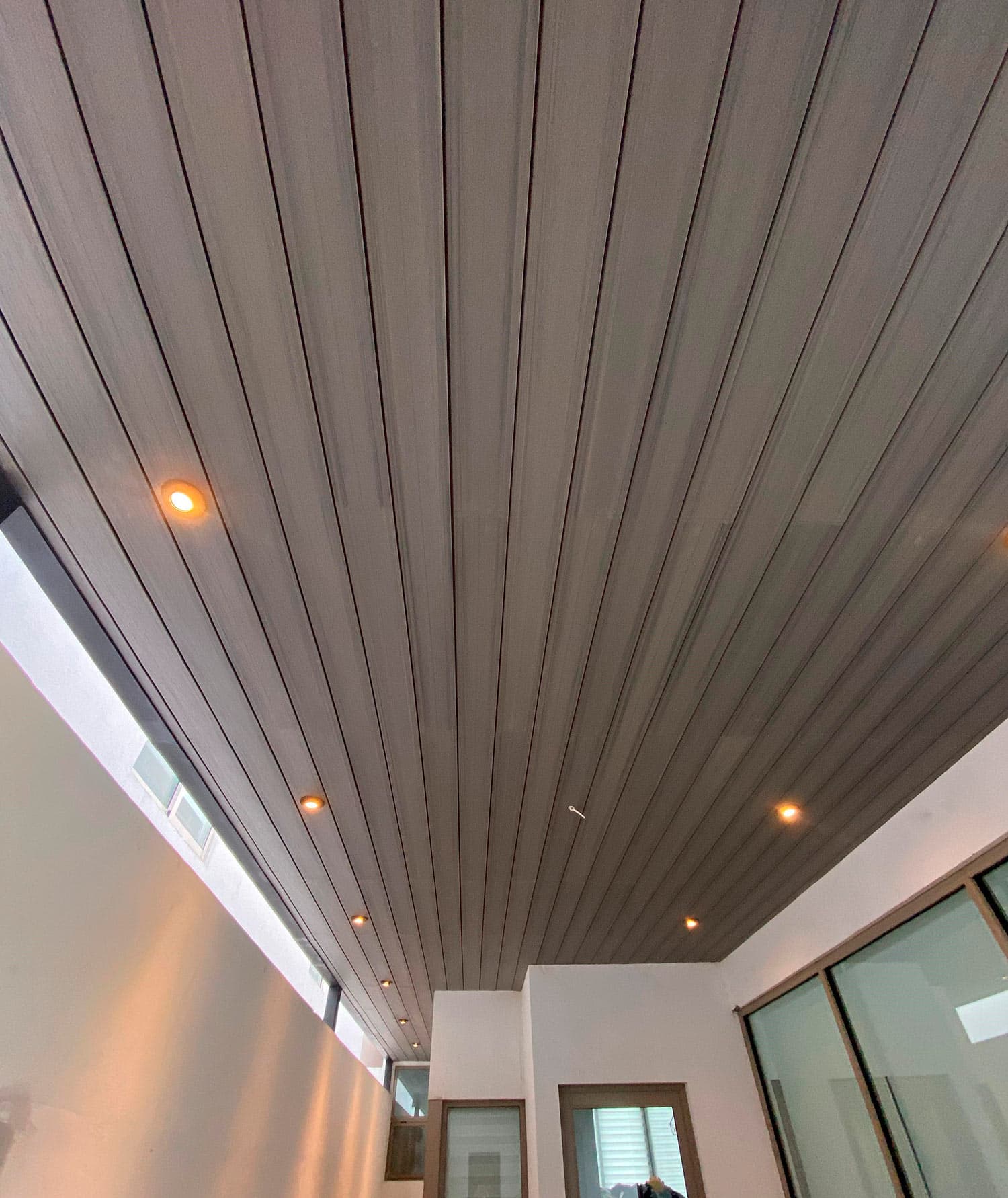 WPC cladding with recessed lights on a patio ceiling