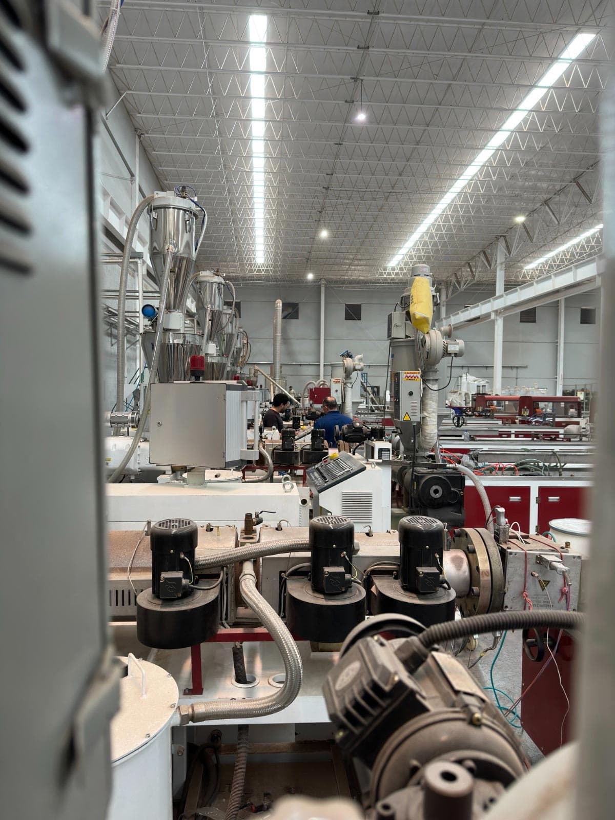 Extrusion lines inside the Extrutech plant in Santa Catarina, Nuevo León, with two operators at work