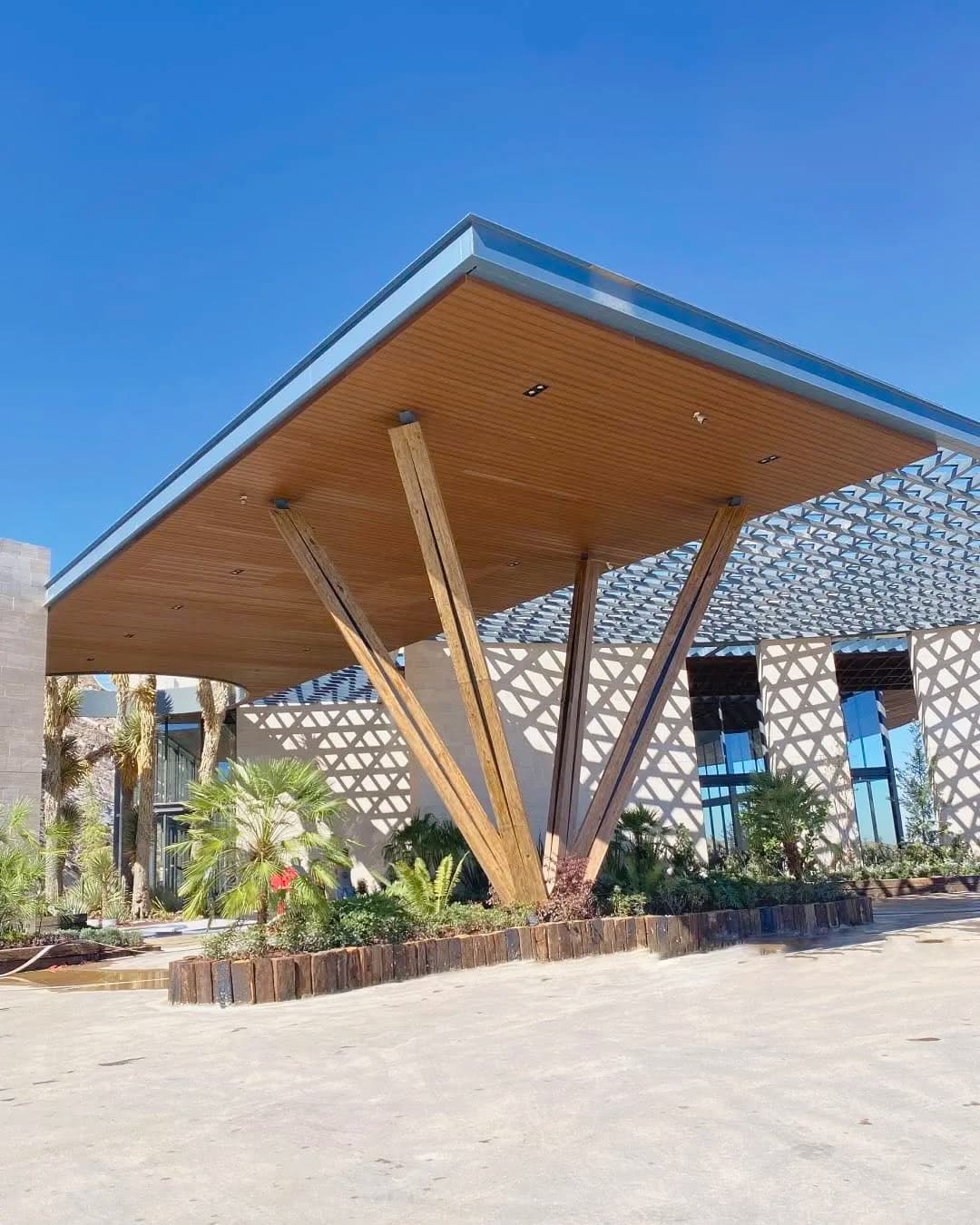 Public park entrance canopy with a WPC board ceiling and a slatted screen