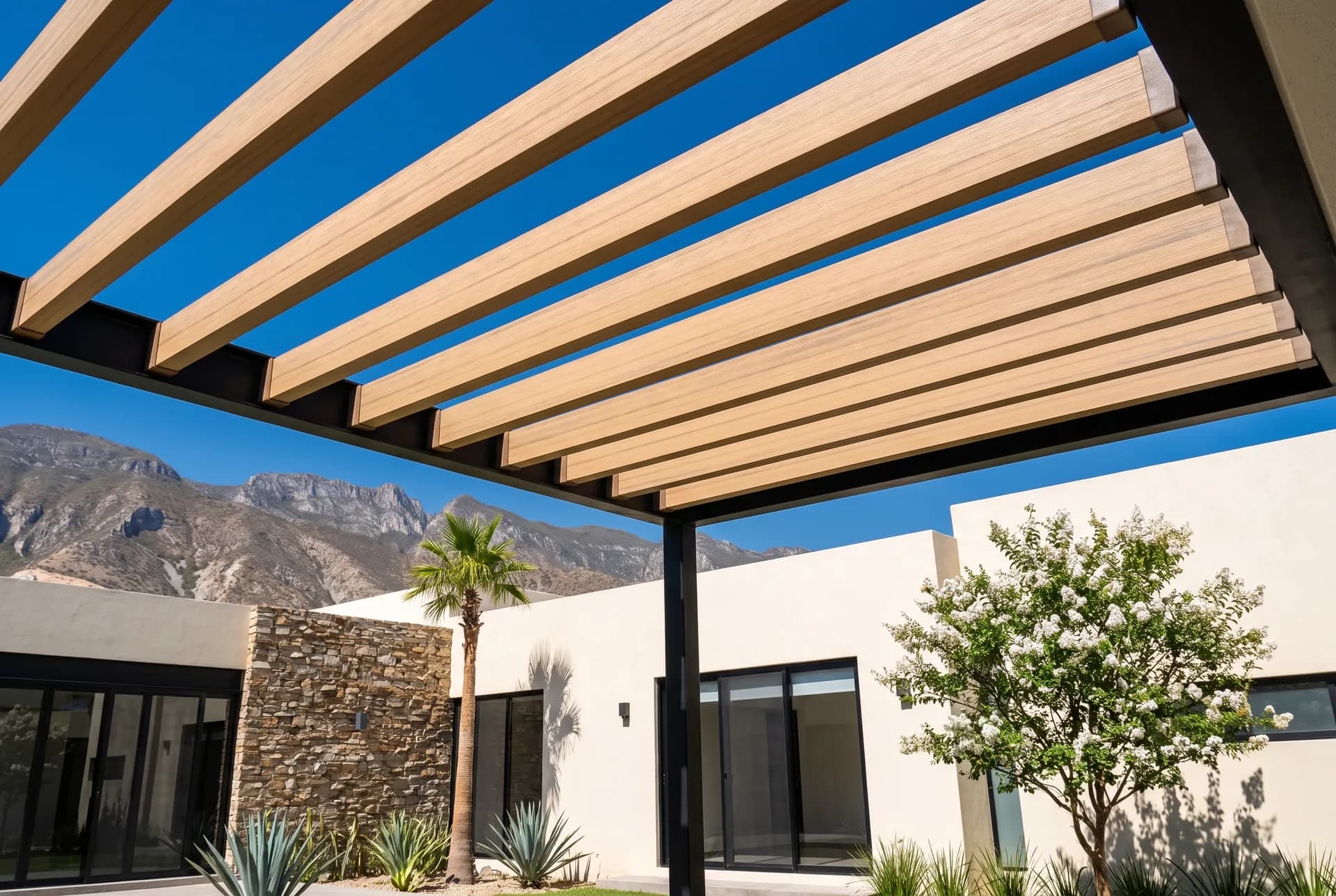 Chesnut WPC beam pergola seen from below against the sky, with the Sierra Madre in the background