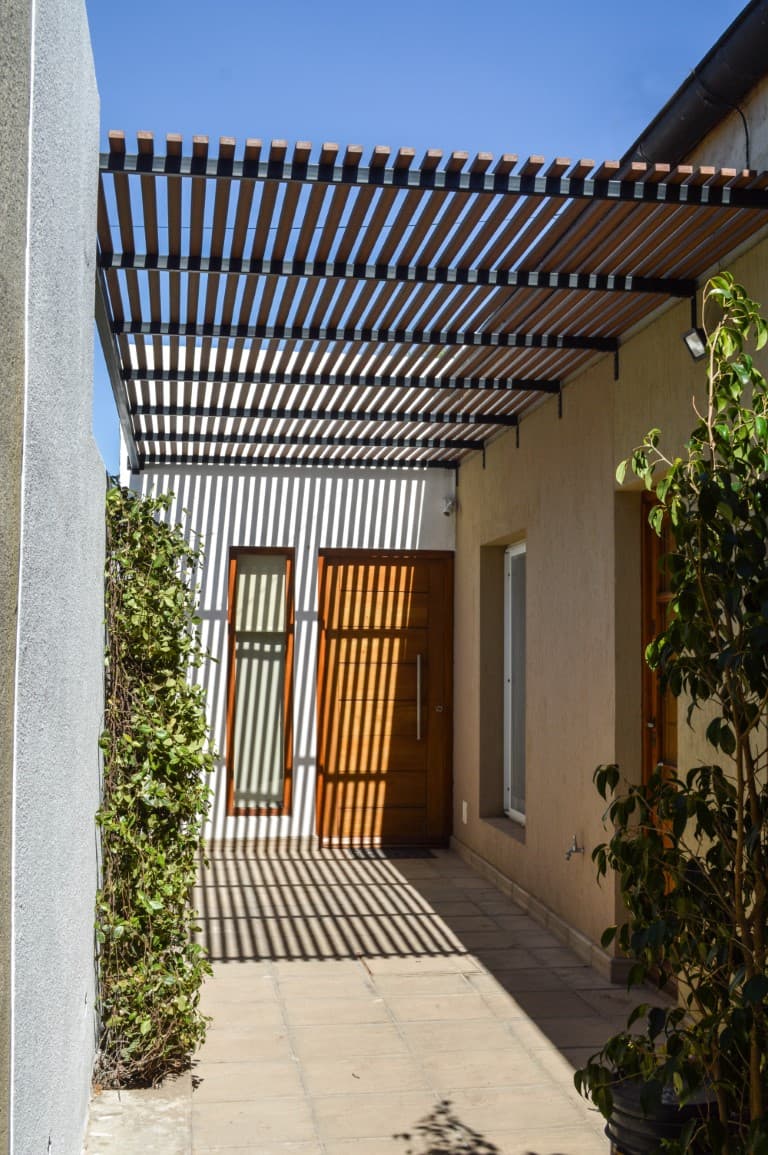 Vertical screen of WPC beams at the entrance of a house